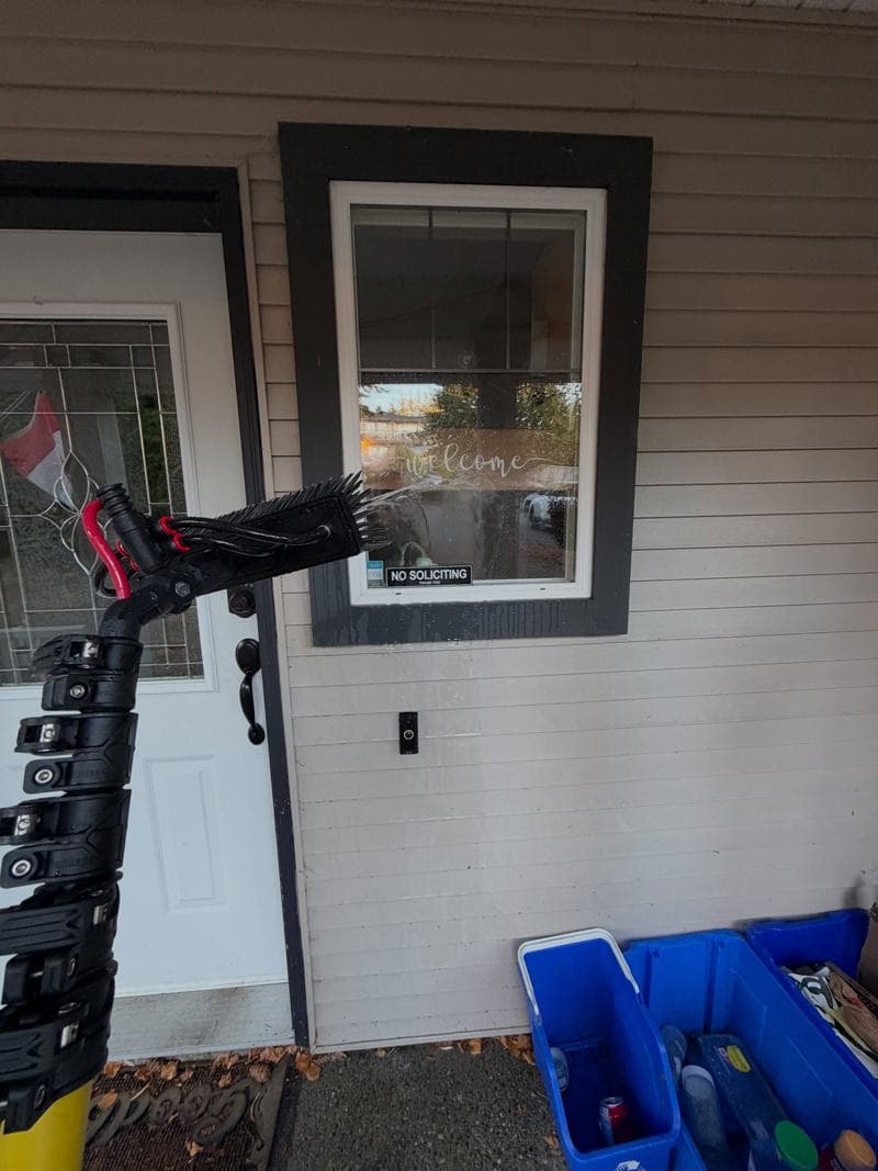 GES cleaning exterior glass with a water-fed brush